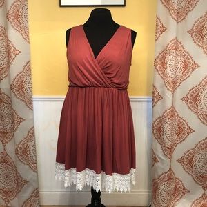 Rust colored, flattering lace trim dress.